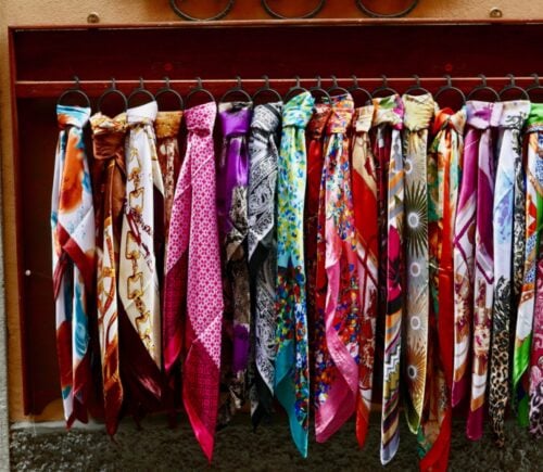 A selection of brightly colored scarves made from silk, a material often considered to be cruel