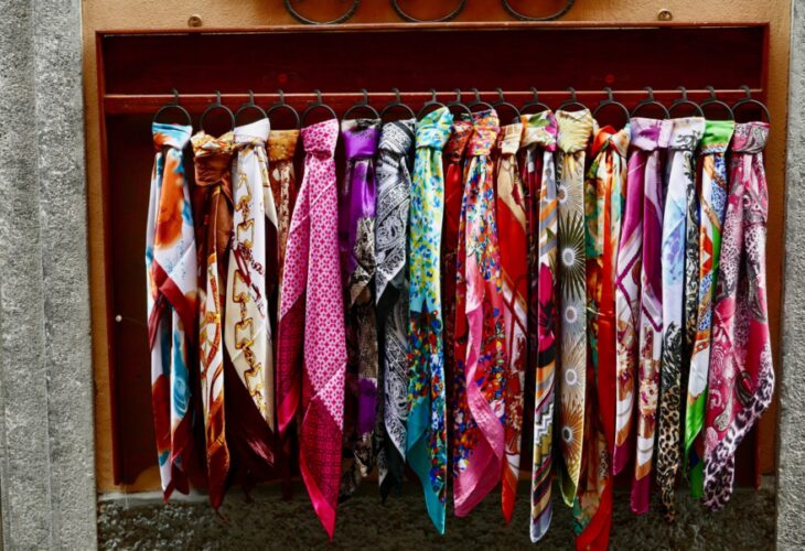 A selection of brightly colored scarves made from silk, a material often considered to be cruel