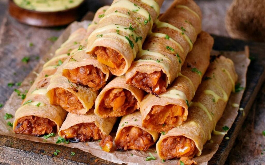 Vegan buffalo taquitos stacked in a pyramid shape