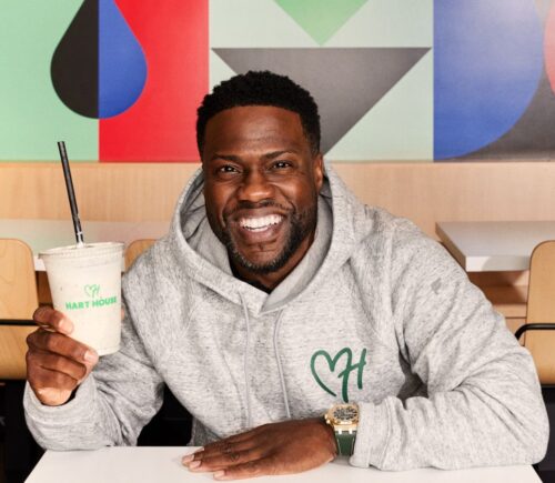 Kevin Hart, founder of vegan fast-food chain Hart House, sitting in the new Hollywood drive-thru location