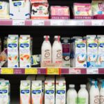 A selection of vegan oat and soy milks, drinks, and cheeses at a UK supermarket