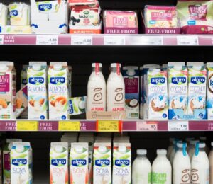 A selection of vegan oat and soy milks, drinks, and cheeses at a UK supermarket