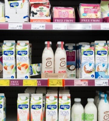 A selection of vegan oat and soy milks, drinks, and cheeses at a UK supermarket