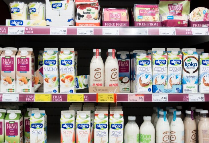 A selection of vegan oat and soy milks, drinks, and cheeses at a UK supermarket