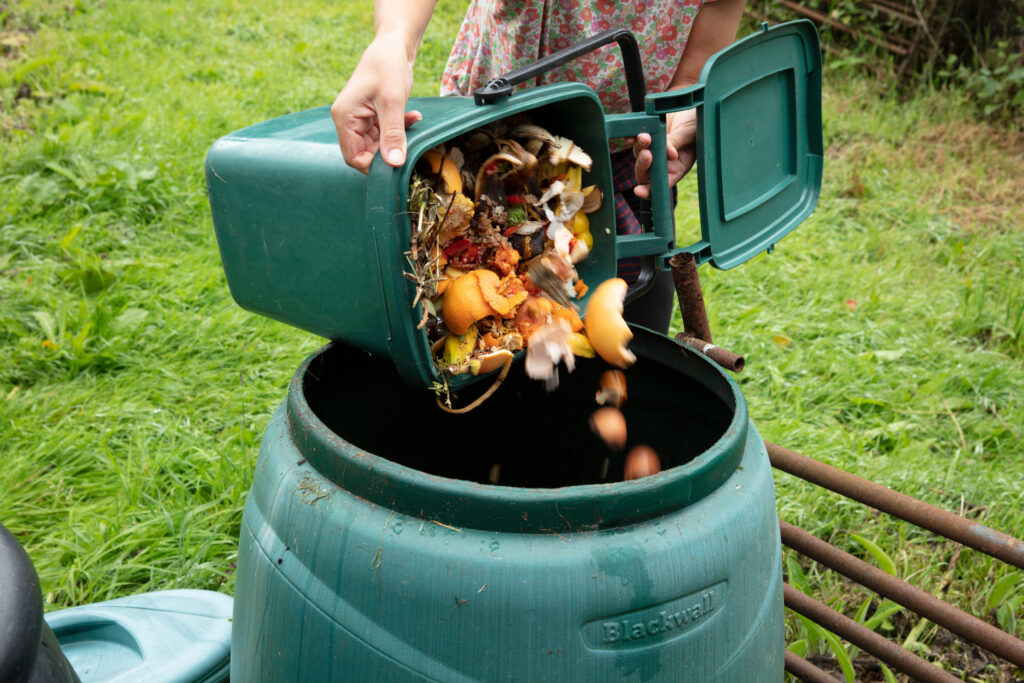 A person composting plant foods