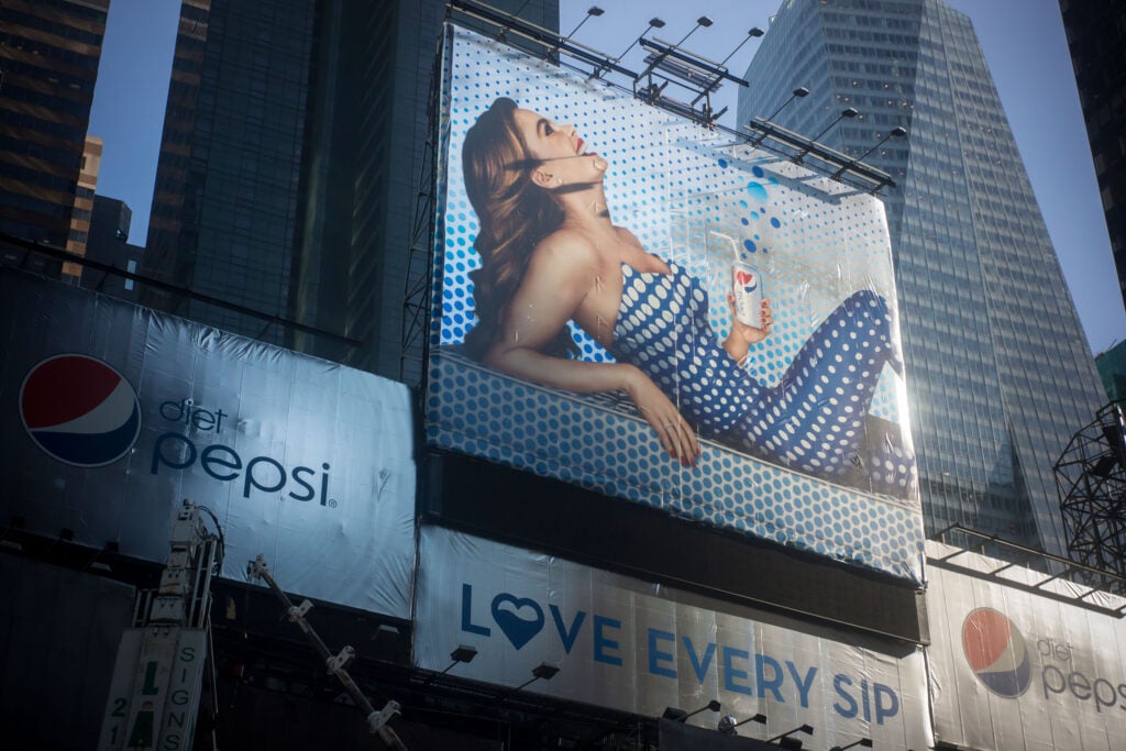 A billboard advert for non-vegan drink Diet Pepsi