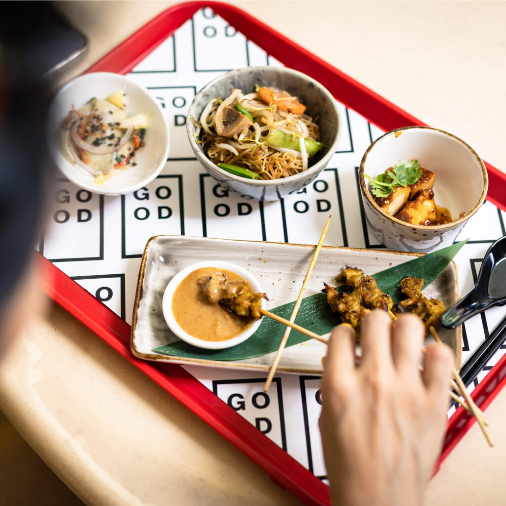 Bowls of food on a tray featuring cultured chicken made by GOOD Meat, a division of Eat Just