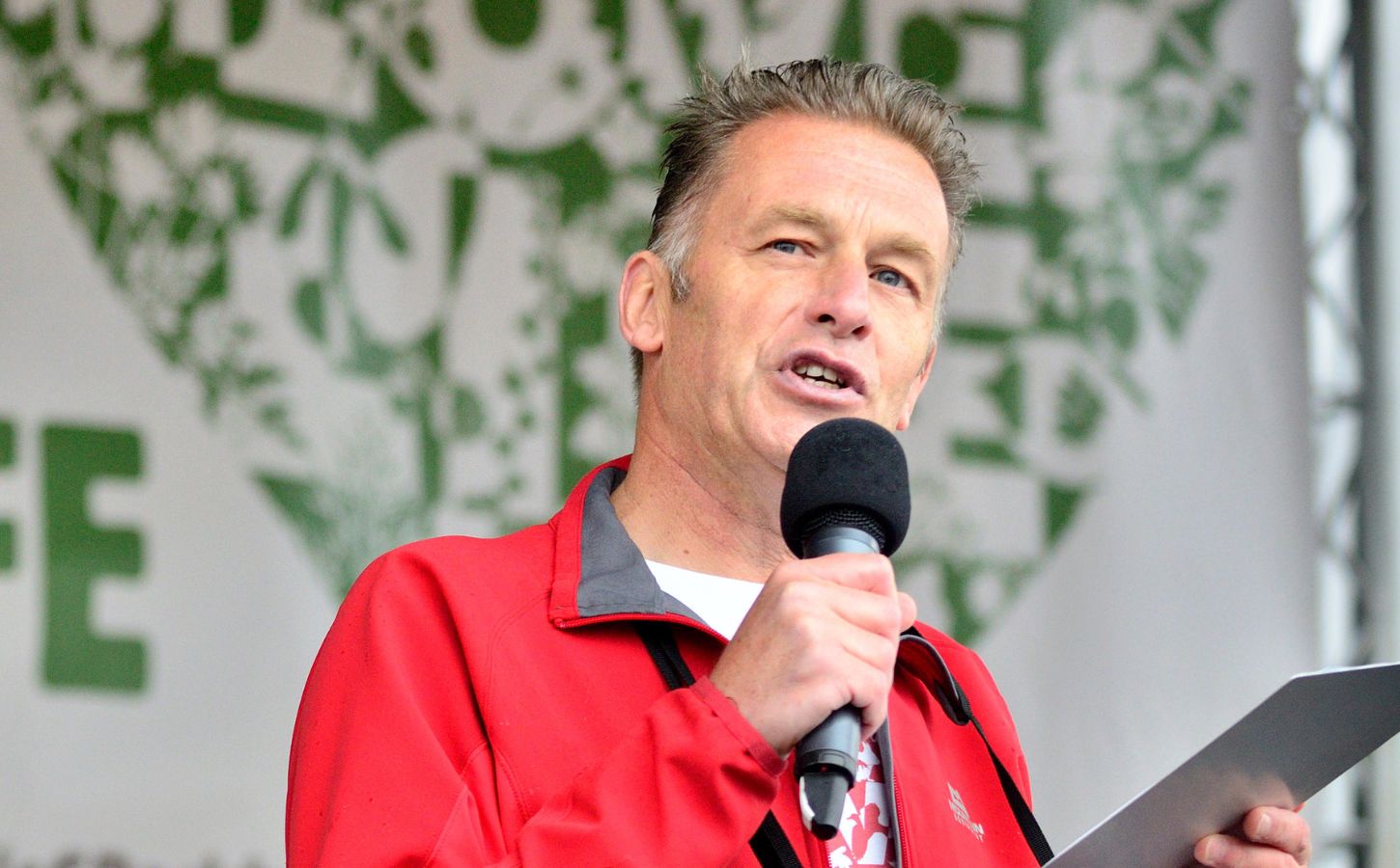 Vegan celebrity Chris Packham giving a speech at an outdoor event