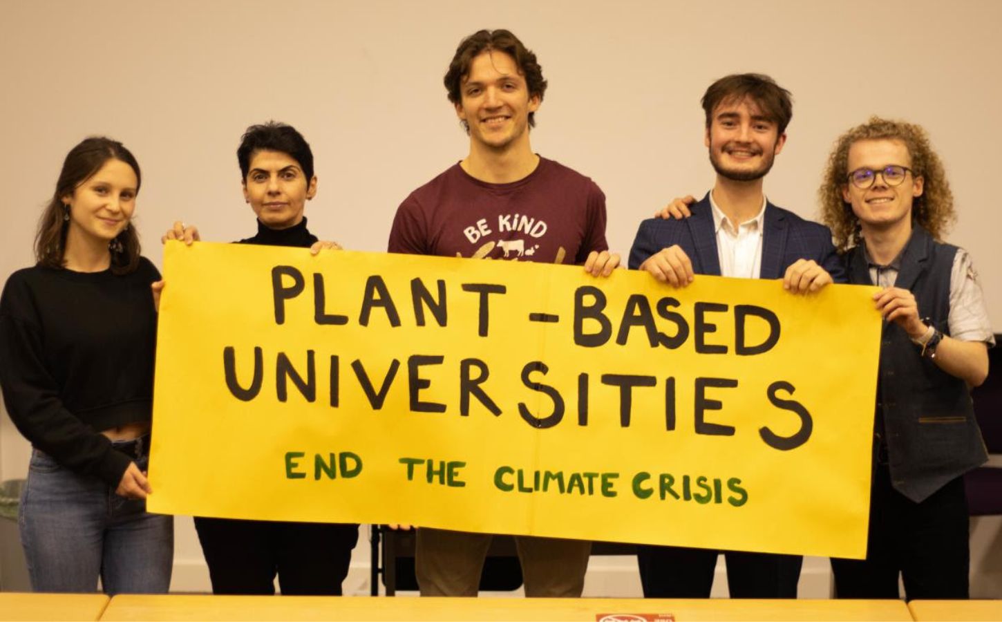 Students at Kent University holding up a banner reading "Plant-Based Universities: End the climate crisis