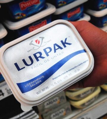 Lurpak spreadable butter being picked up from a supermarket shelf