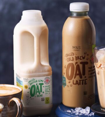 A vegan oat milk carton beside some milky dairy-free drinks