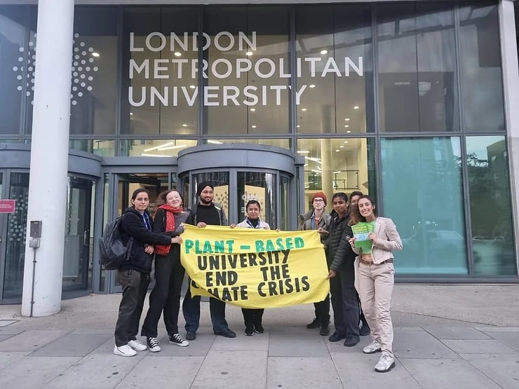 Students at London Metropolitan University holding up a Plant-Based Universities banner