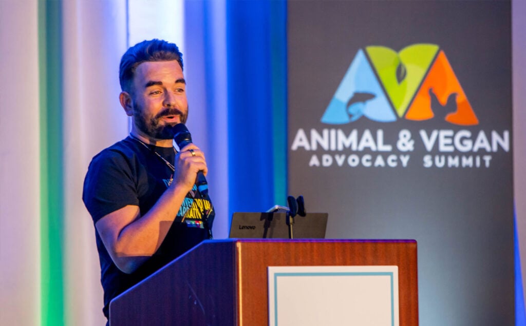 Robbie Lockie, cofounder of Plant Based News speaking on stage at AVA Summit USA