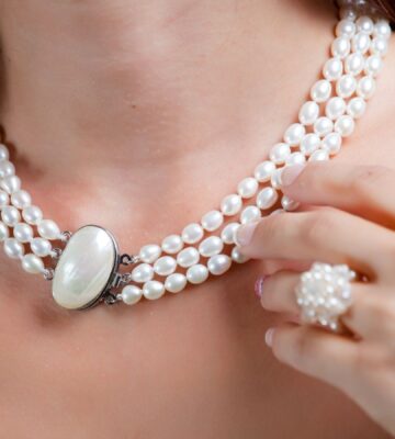 A woman wearing a pearl necklace, which is not suitable for vegans