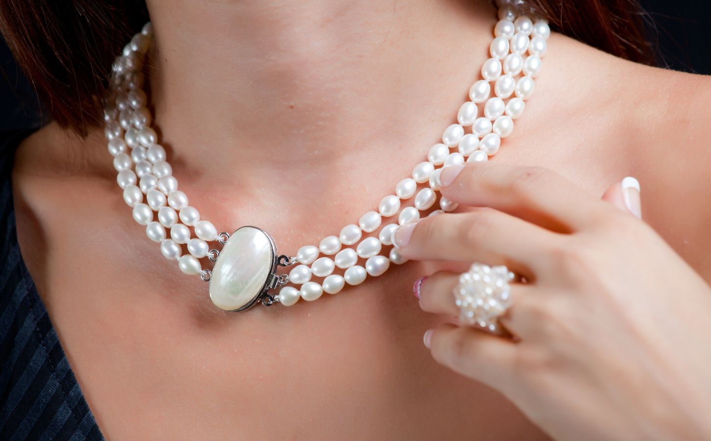 A woman wearing a pearl necklace, which is not suitable for vegans