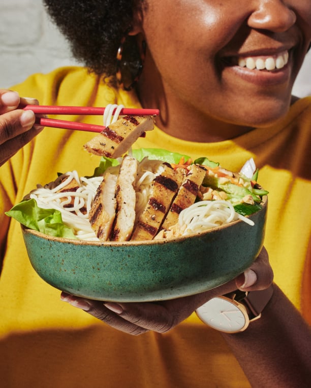 A person eating a salad with cultivated chicken from BELIEVER Meats