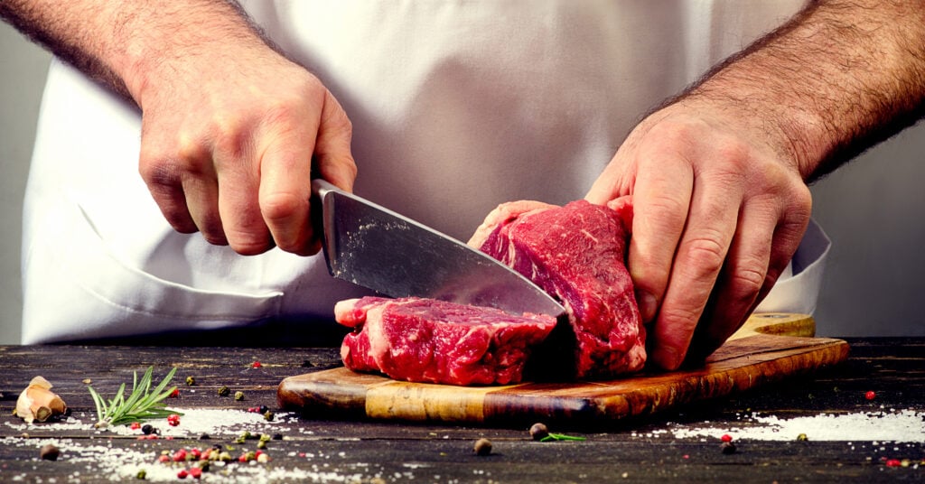A man cutting meat