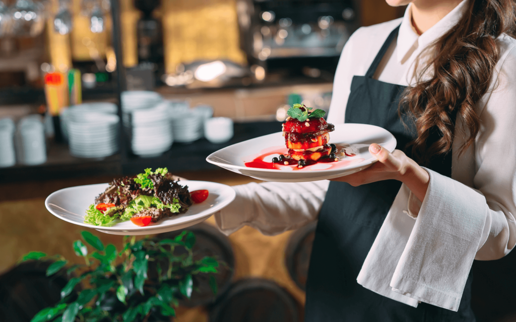 A waiter serving meat dishes at an event