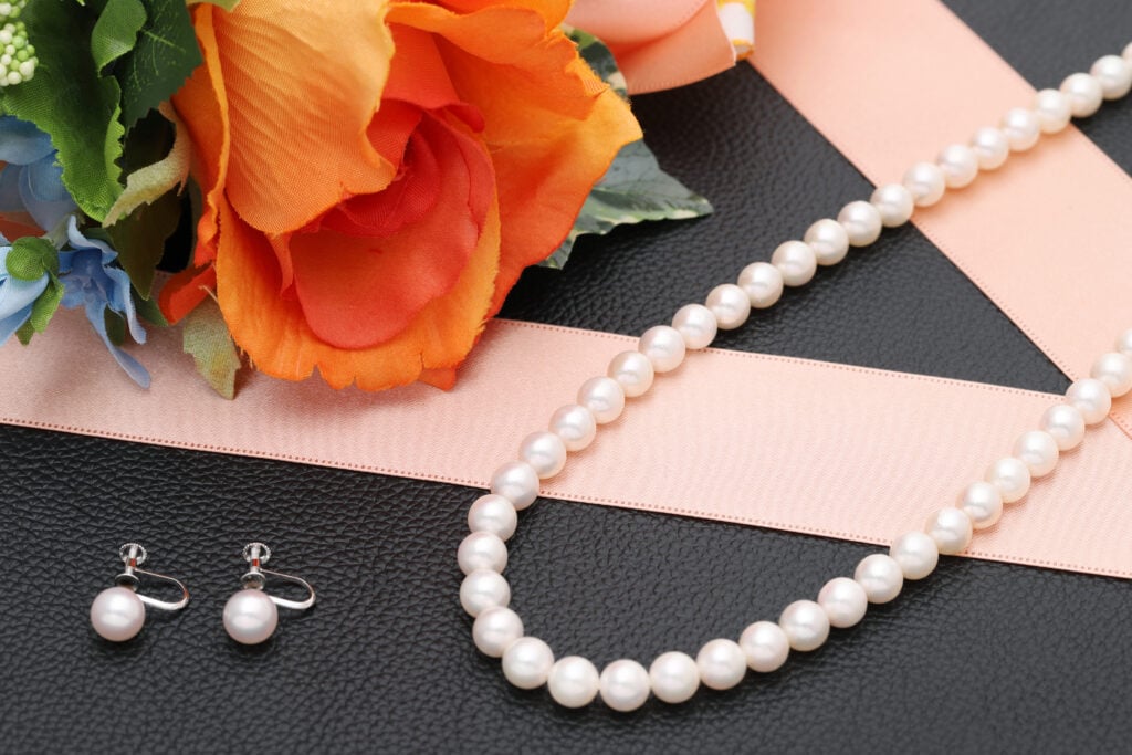 A non-vegan pearl necklace and earrings