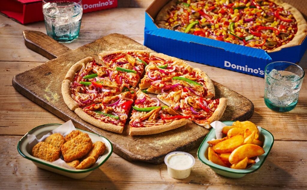 A vegan pizza and sides at Domino's, which are part of the pizza chain's plant-based menu