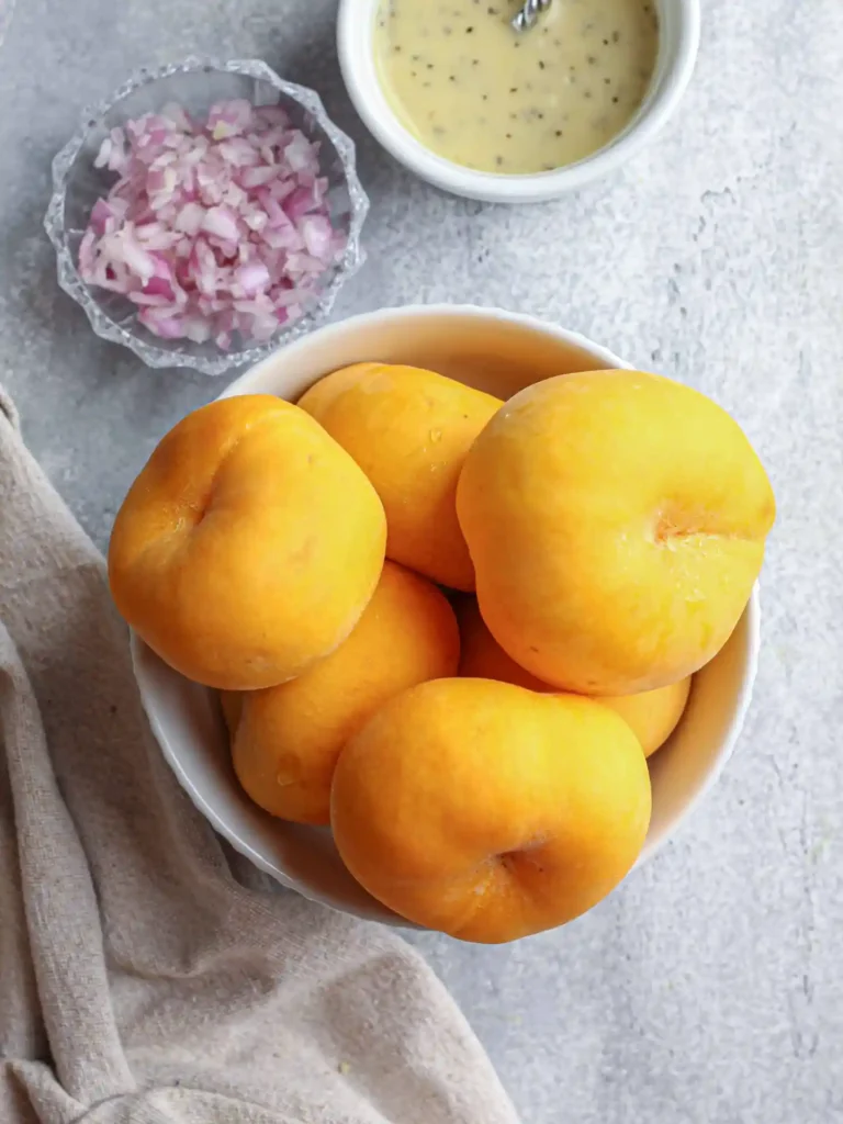A bowl of peaches on the table for a vegan pasta salad recipe