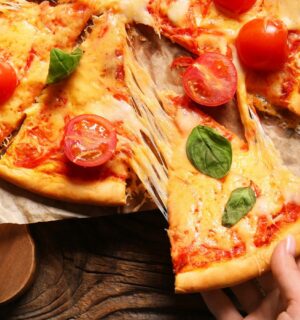 A pizza with tomatoes and cheese made from dairy milk