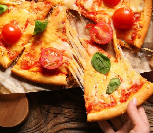 A pizza with tomatoes and cheese made from dairy milk