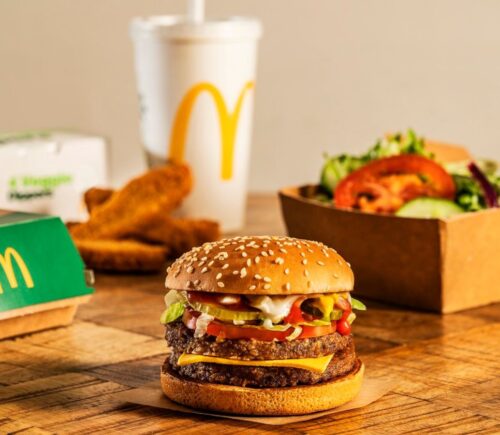 A selection of McDonald's vegan items, including a plant-based burger, drink, and salad, off the meat-free menu