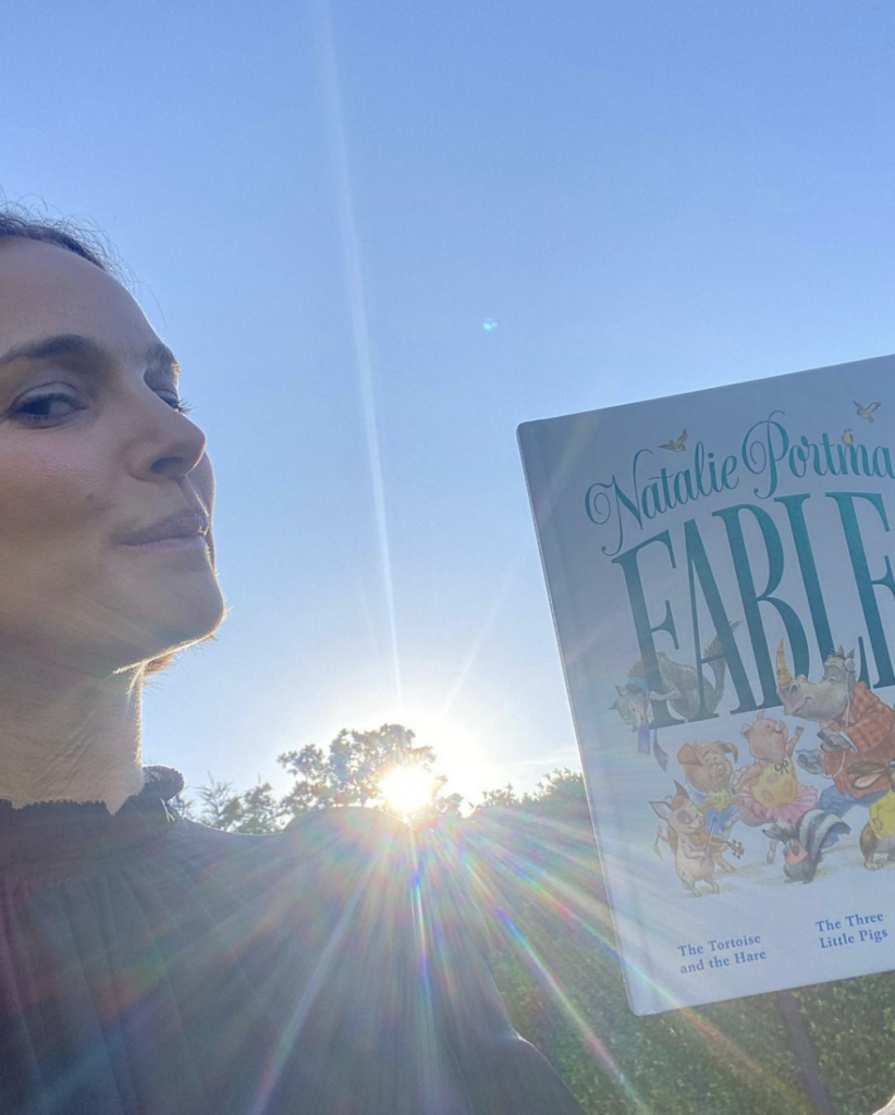 Vegan celebrity Natalie Portman holding her book