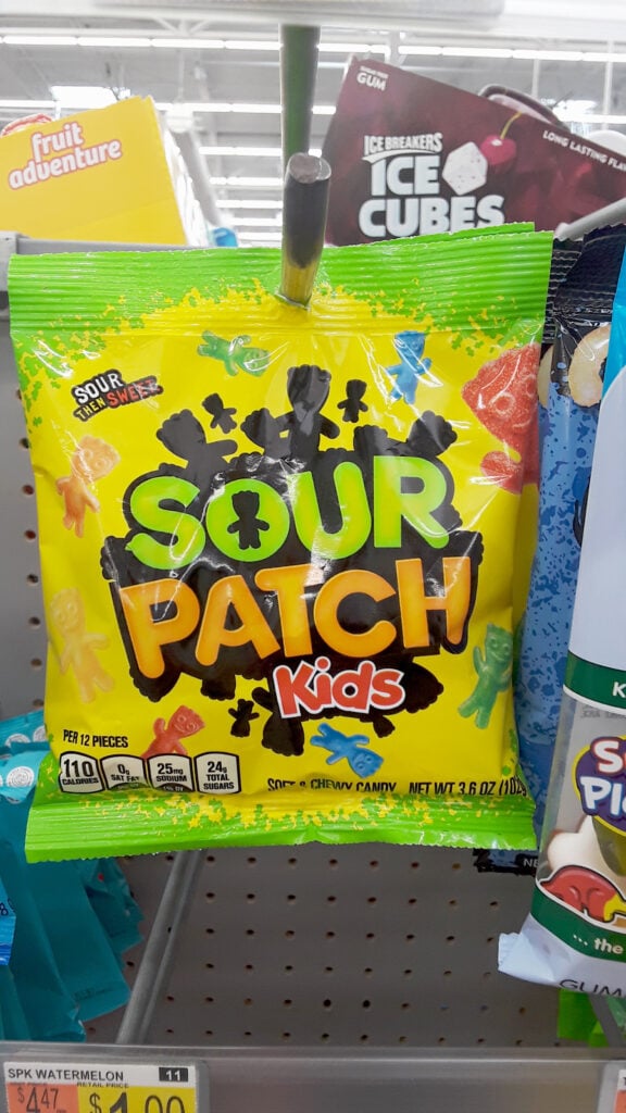 Sour patch kids, a non-vegan candy containing gelatin, on the supermarket shelf
