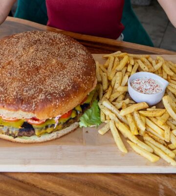 Reportedly the biggest vegan burger in Thailand next to a large portion of chips
