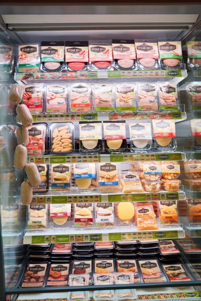 Vegan cheeses and meats on a supermarket shelf