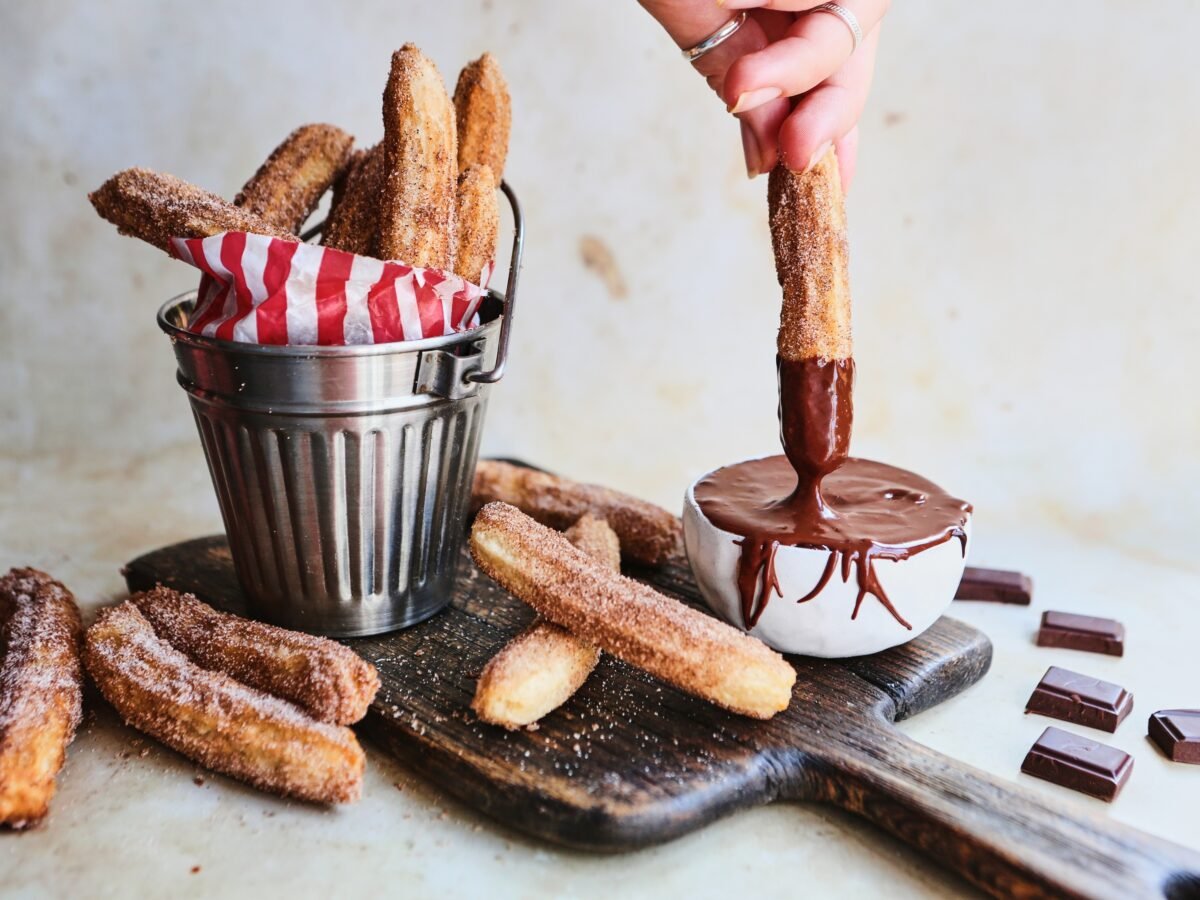 Vegan churros with orange chocolate dipping sauce made from a vegan recipe