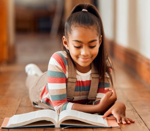 A child reading a vegan-friendly children's book
