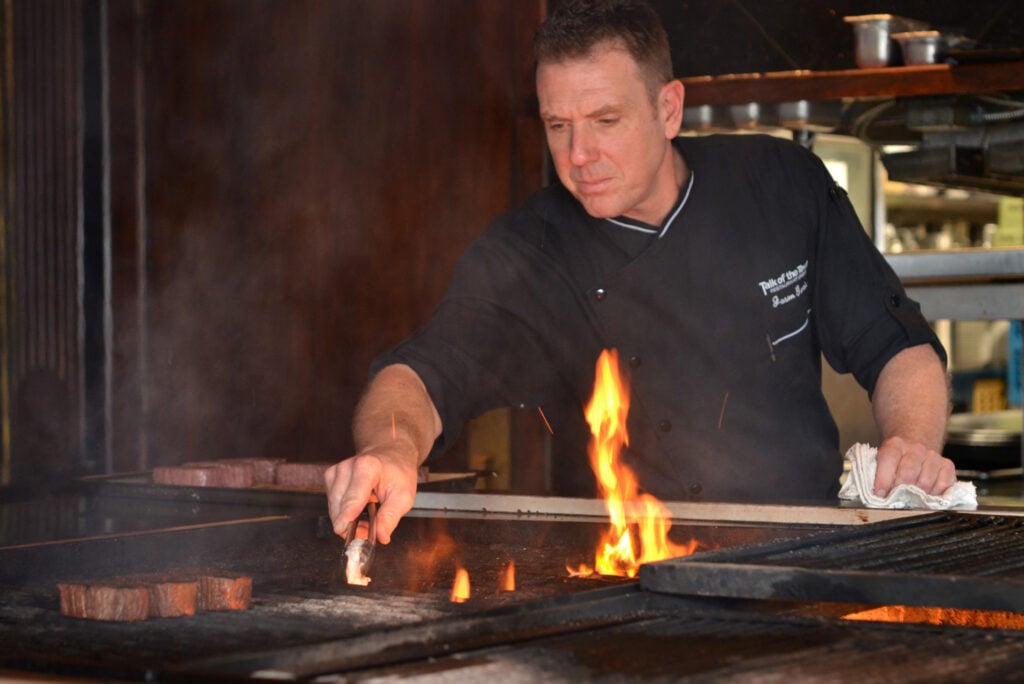 a chef cooking plant-based steak at a steakhouse