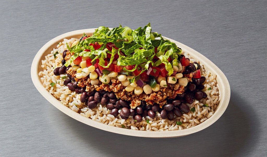 Chipotle vegan bowl containing lettuce, beans, and rice