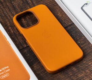 An orange Apple iPhone 13 Pro leather case