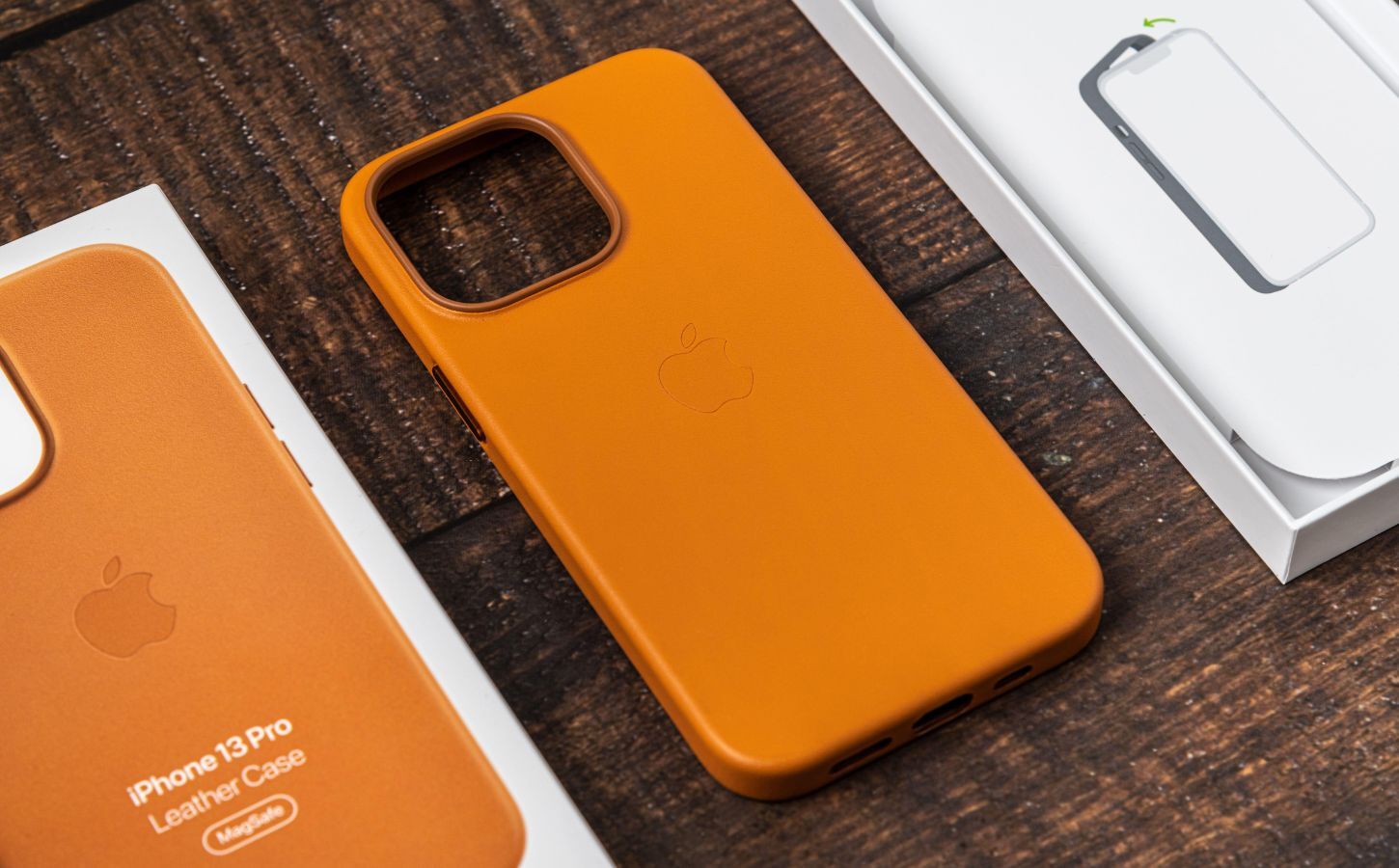 An orange Apple iPhone 13 Pro leather case