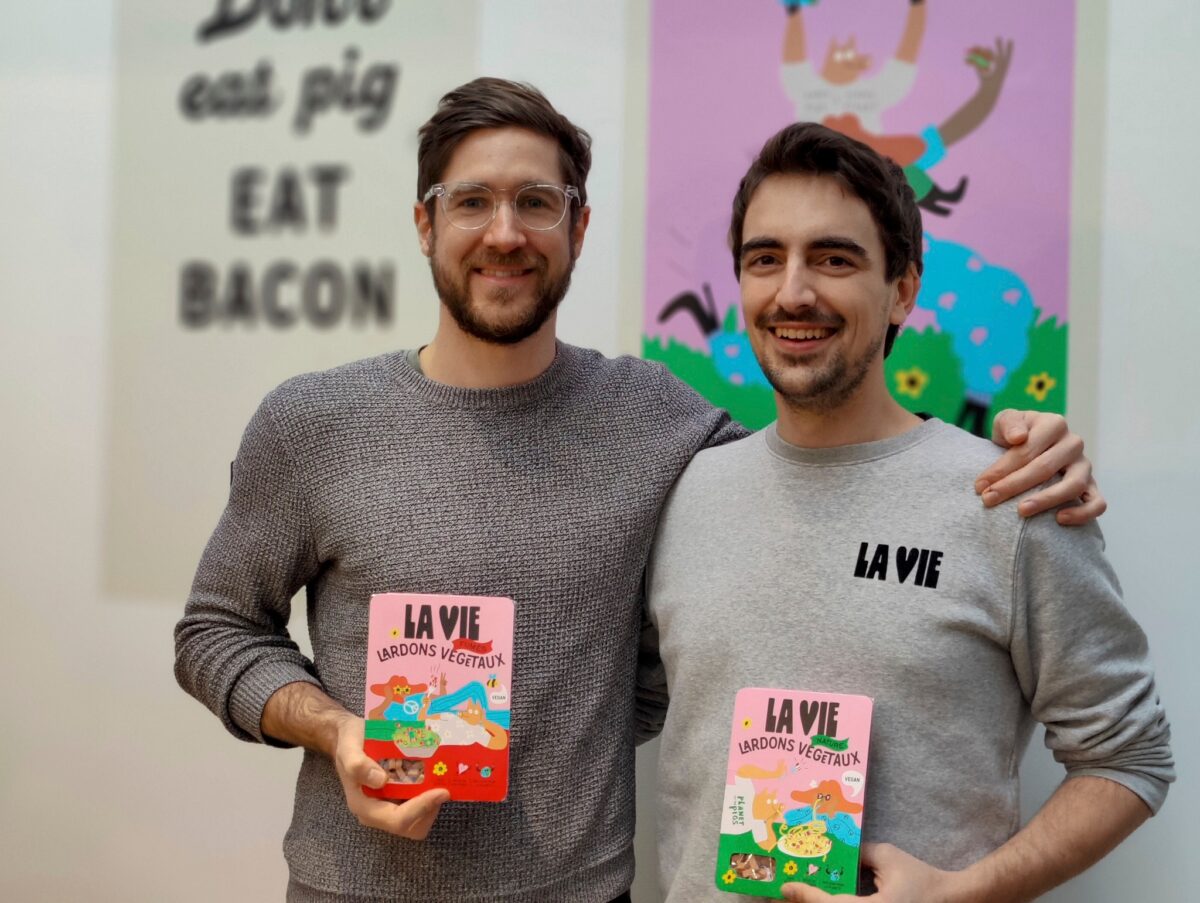 La Vie co-founders Nicolas Schweitzer and Vincent Poulichet holding up packs of vegan lardons. 