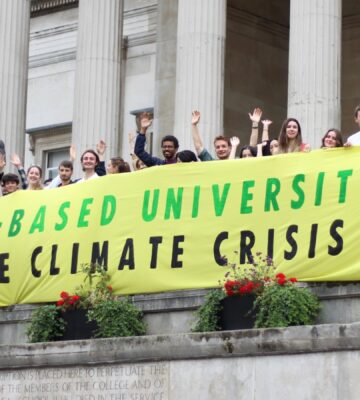 Students from the Plant-Based Universities campaign holding up a banner calling for vegan catering