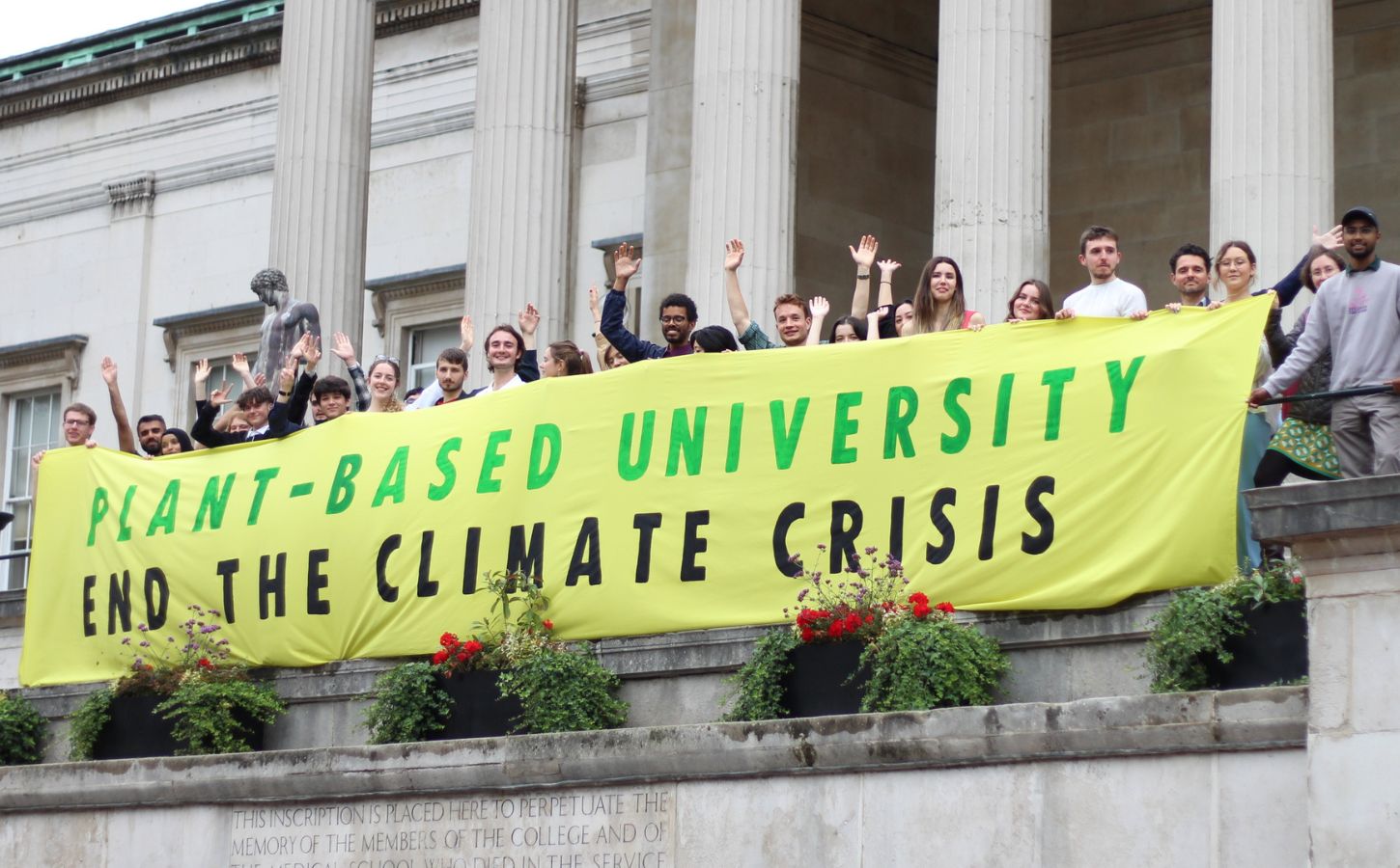 Students from the Plant-Based Universities campaign holding up a banner calling for vegan catering