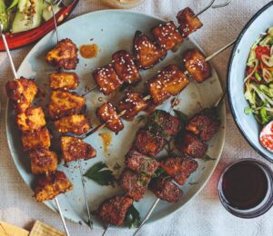 Vegan chicken skewers on a plate, a plant-based meat recipe from a new BOSH! cookbook