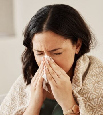 Close-up short of woman with allergies sneezing