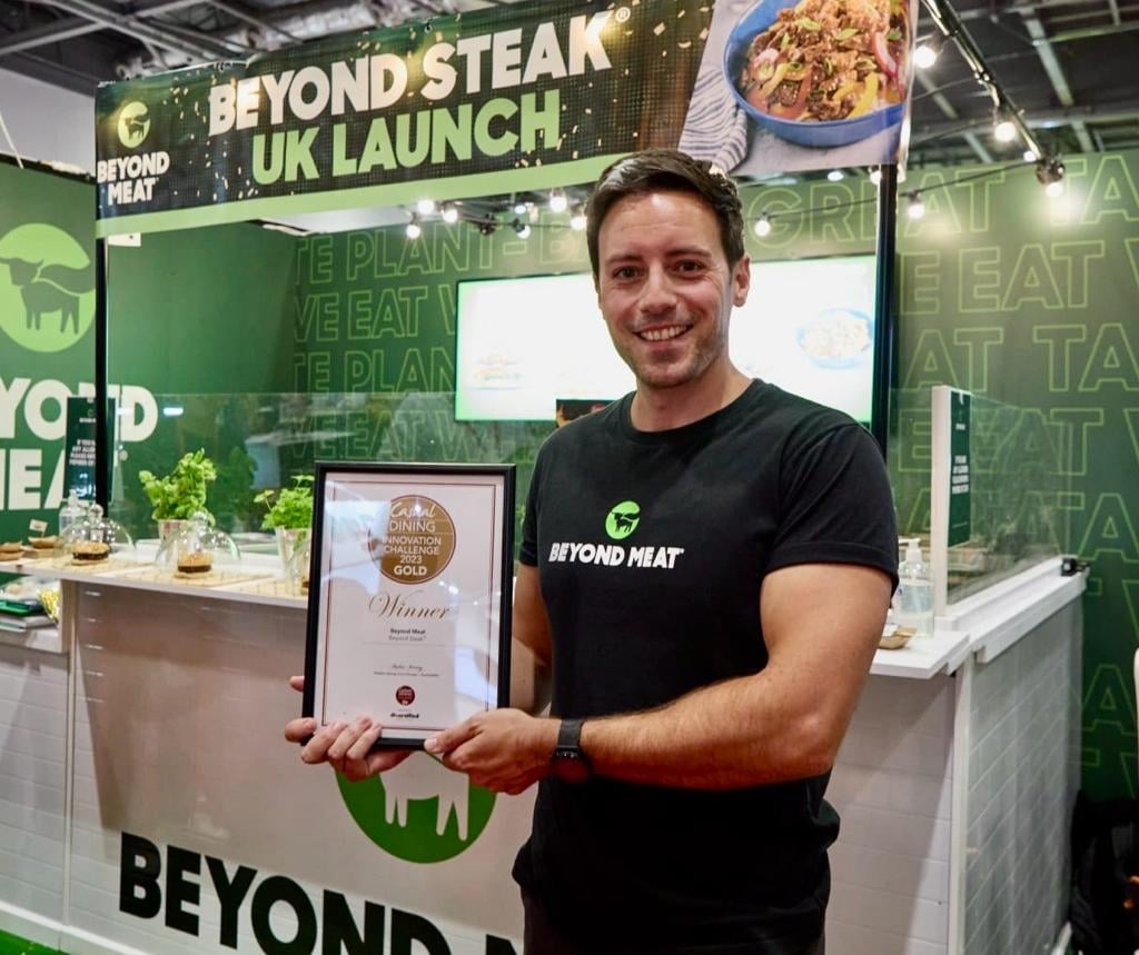 Beyond Meat's Steve Parson's holding up the vegan steak's Casual Dining Show award 