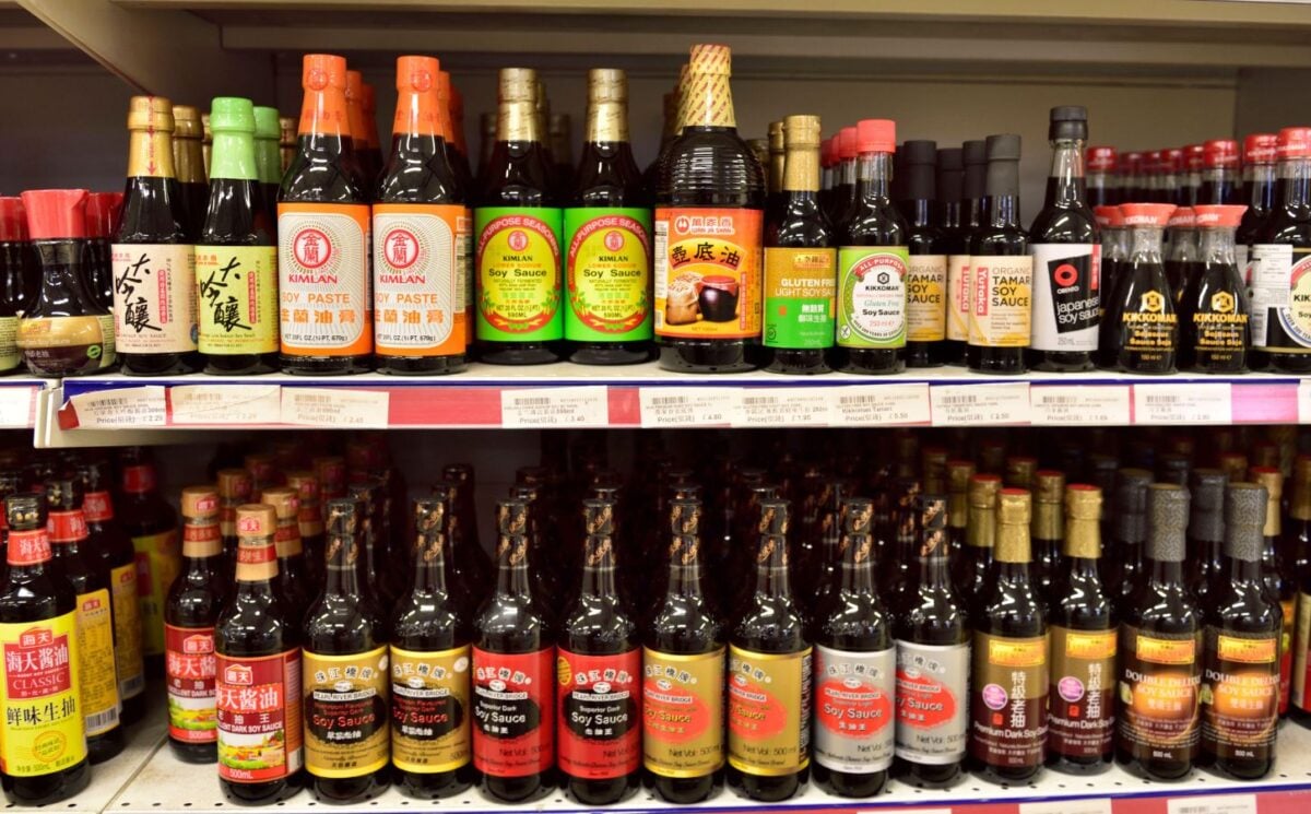 Vegan fish sauce substitutes in a supermarket, including soy sauce