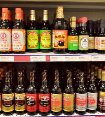 Vegan fish sauce substitutes in a supermarket, including soy sauce