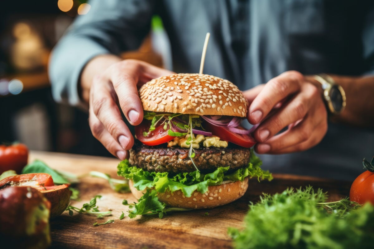 Close-up of a man preparing vegan burger