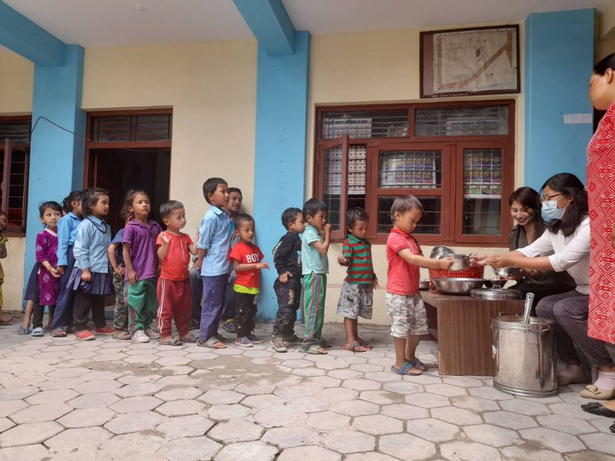 Children receiving vegan meals from Food For Life