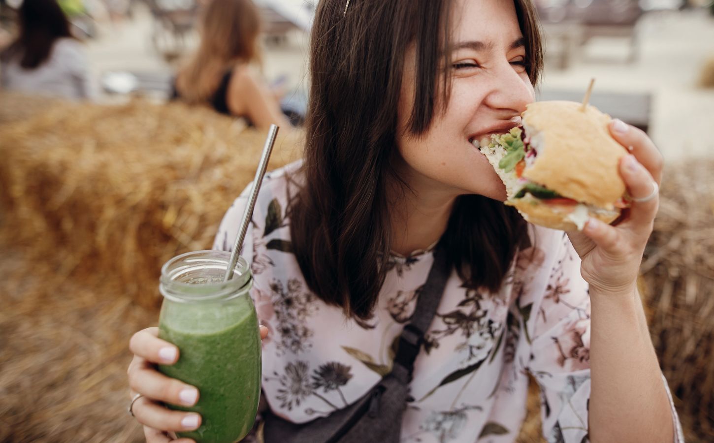 Woman eating a vegan burger in the US