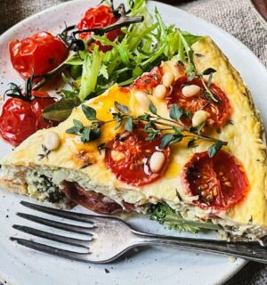 A vegan cheese and tomato quiche made with dairy-free ingredients